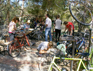 Pessoas consertando bicicletas na Oficina das Bicicletas no CERES