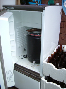 An old upside down fridge used to regulate the temperature while the wort is fermenting