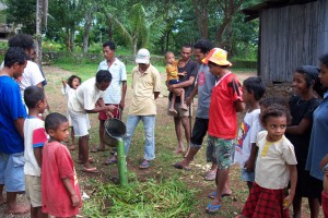 Permatil workshop demonstrating using a bamboo watering pipe for fruit trees